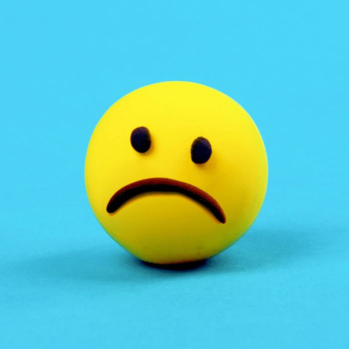 frowning yellow face on a light blue background