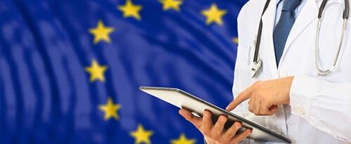 doctor with tablet in front of EU flag