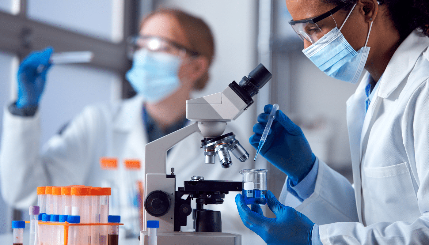 medical professional examining samples with microscope