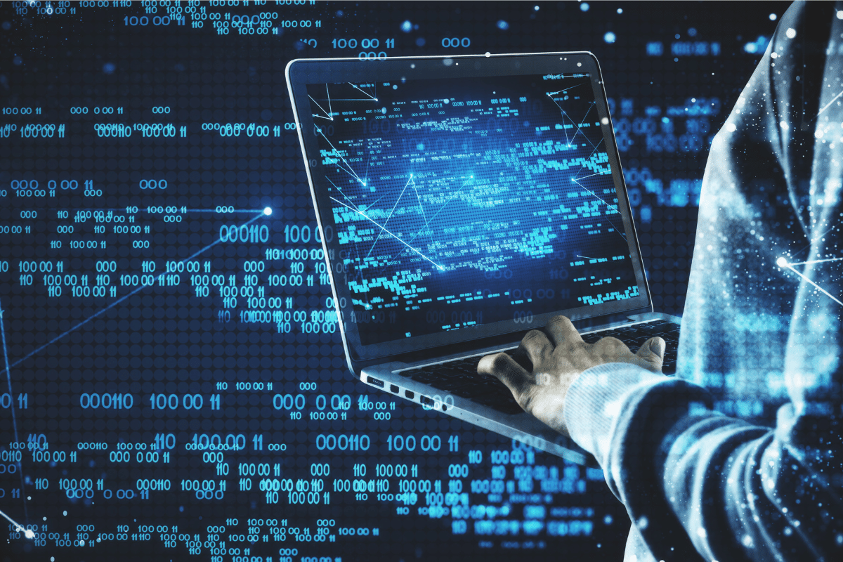 person using computer with abstract technology graphics over top