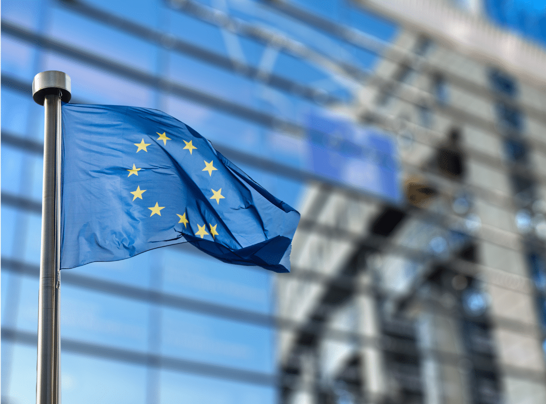 european union flag flying next to building