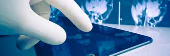 close-up of medical professional using tablet