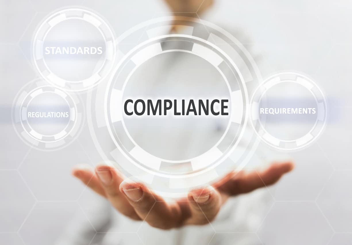 hand holding up compliance bubble