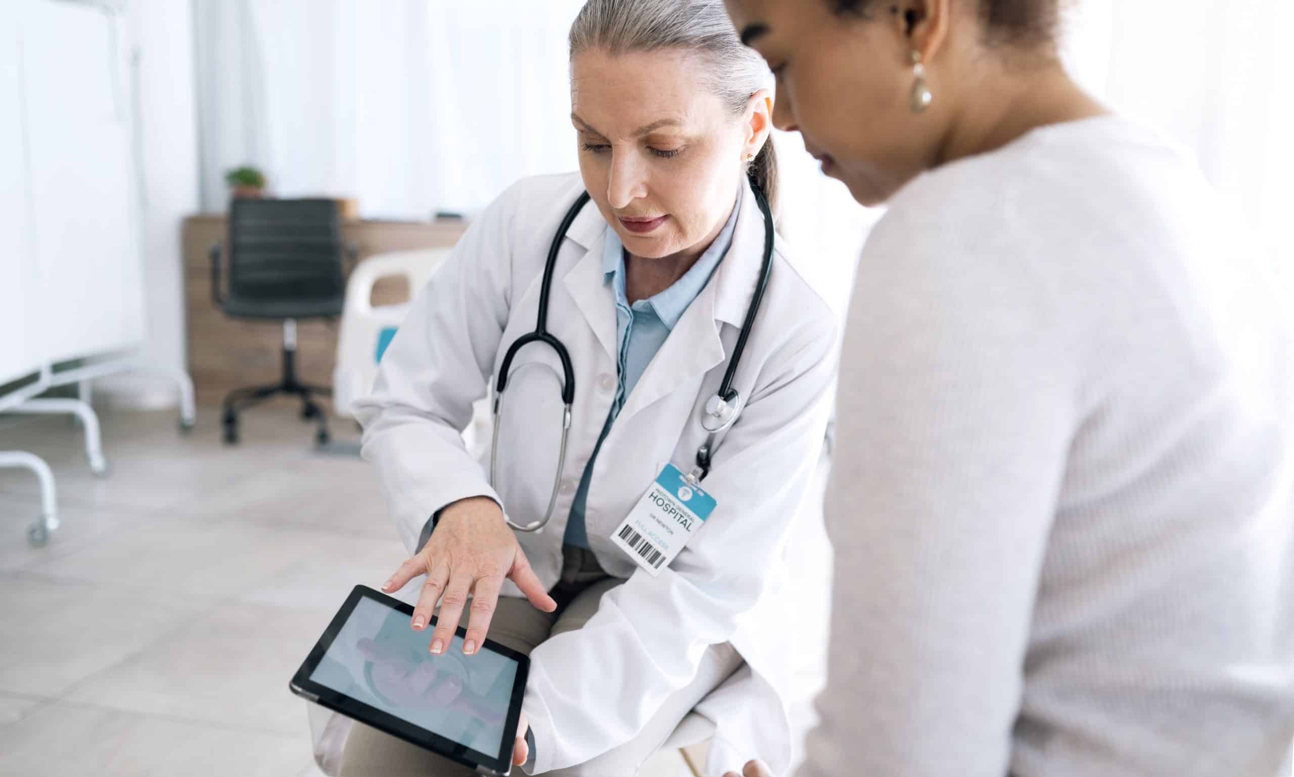 Doctor showing results on a tablet